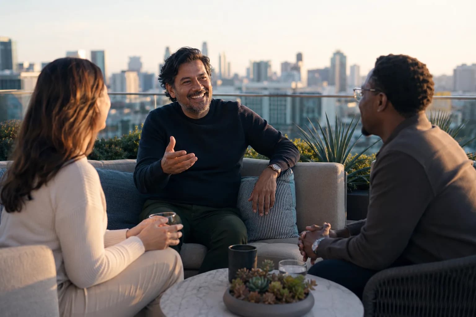 A founder confidently holding court with colleagues on a sunlit rooftop terrace, illustrating the closed authority gap where a real reputation finally matches what buyers find online.