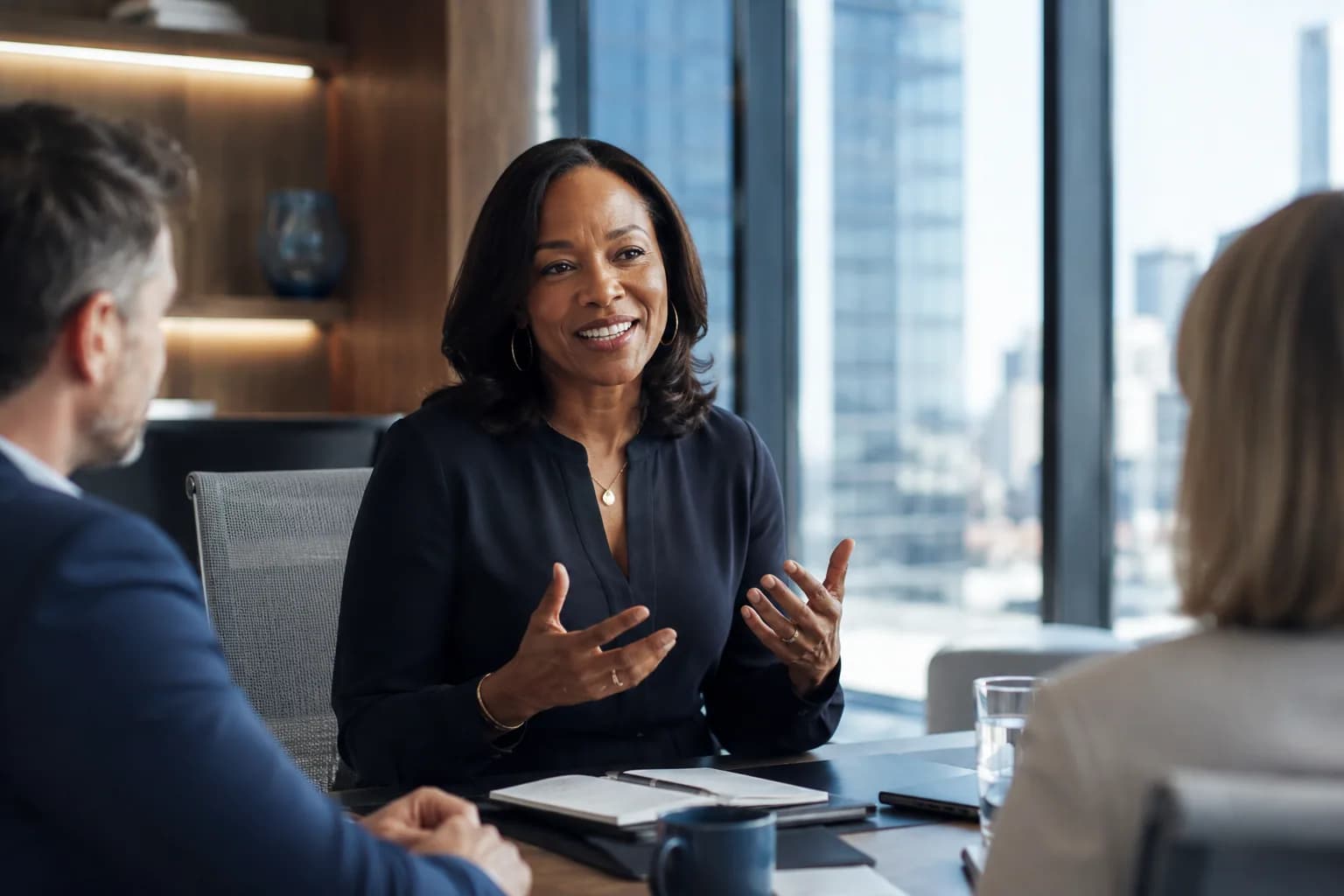 A poised CEO leading an engaged conversation with colleagues in a bright modern office, illustrating how CEO visibility turns leader presence into company growth.