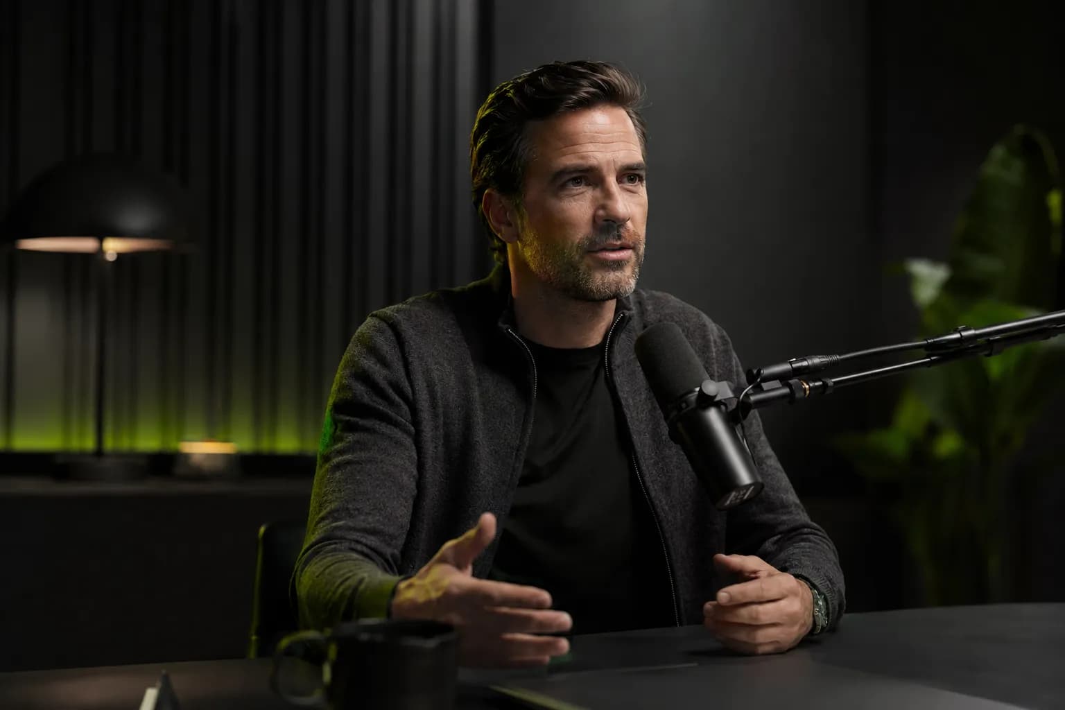 A founder recording a podcast in a sophisticated studio, illustrating personal branding for entrepreneurs built on earned media rather than constant posting.