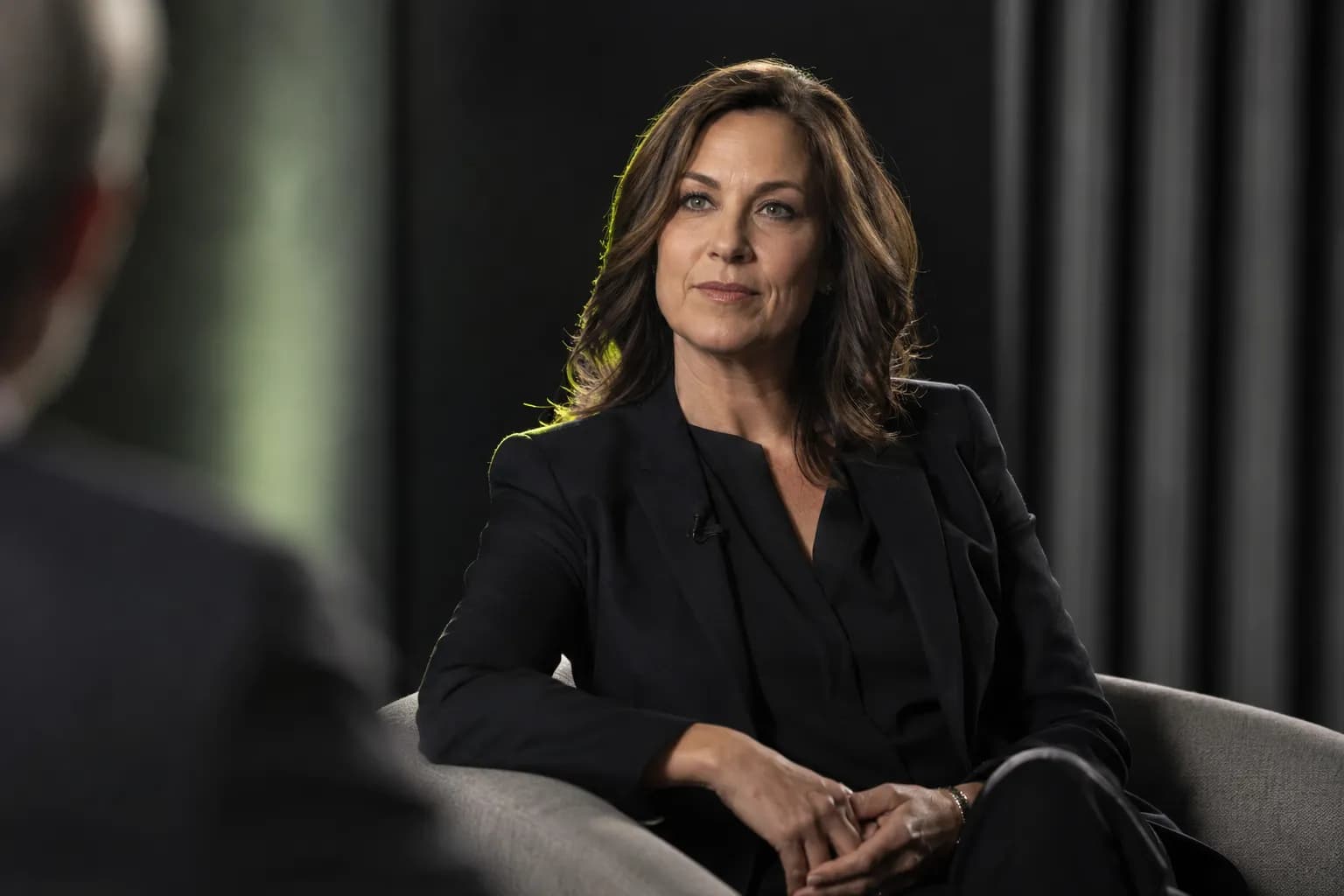 A woman leader being interviewed in a professional media setting, illustrating personal branding for women built on visible authority and earned recognition.