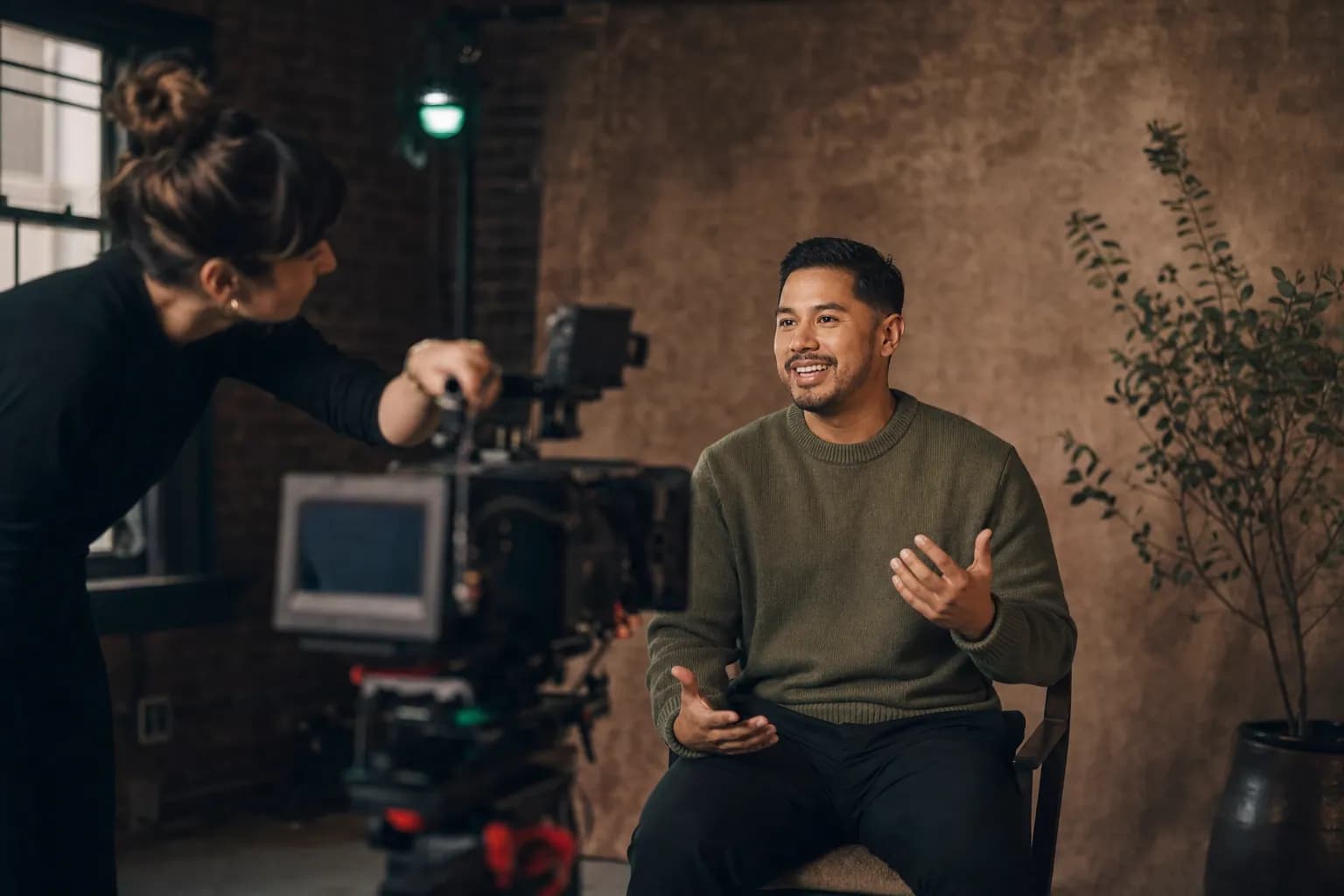 Founder content strategy in action as a Latino male founder records a long-form video interview in a premium studio, turning one recorded conversation into a month of distributed content.