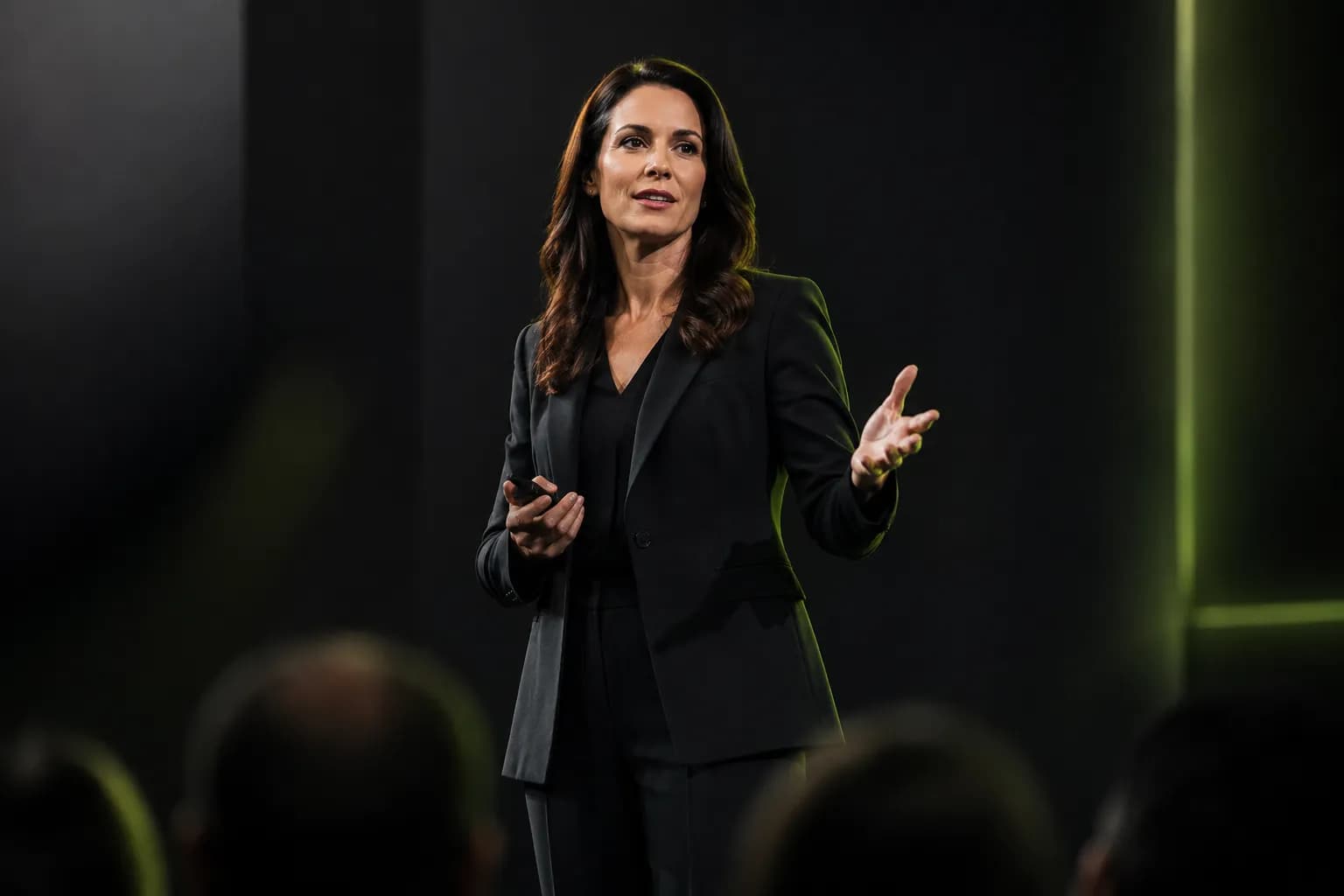 A confident woman founder speaking on a keynote stage, illustrating personal branding for female entrepreneurs built on authority and earned media.